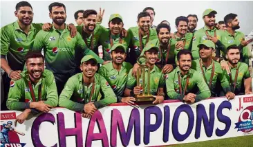  ?? — AFP ?? All smiles: Pakistan team posing with the trophy after winning the third and final T20 match against Sri Lanka on Sunday.