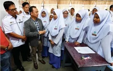  ??  ?? Maszlee shares a light moment with students. — Bernama photo