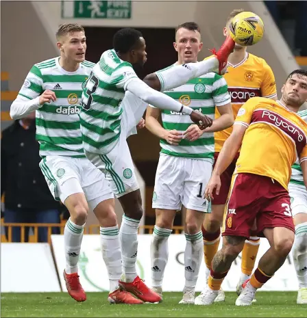  ?? ?? Boli Bolingoli stretches for the ball during a rare start for Celtic at Fir Park. David Turnbull (right) put the