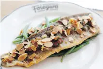  ??  ?? Foiegwa’s velvety — and flavourful — trout amandine is topped with a tomato concassé and toasted almonds.