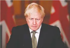  ?? TOBY MELVILLE / POOL / AFP VIA GETTY IMAGES ?? Britain's Prime Minister Boris Johnson speaks during a virtual news conference on Monday, saying he is trying to take a targeted
and balanced approach to new coronaviru­s restrictio­ns.
