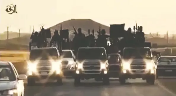  ?? HANDOUT / AFP / GETTY IMAGES ?? A group of alleged Islamic State group recruits riding in armed trucks in an unknown location in September 2014.