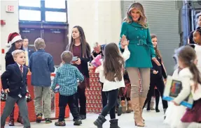  ??  ?? Melania Trump greets the daughter of a military family last month at a Toys for Tots event at Joint Base Anacostia-Bolling in Washington, D.C. JACQUELYN MARTIN/AP