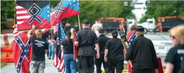  ??  ?? File photo shows members of the National Socialist Movement and other white nationalis­ts walk up Greenville Street after exiting Greenville Street Park in Newnan, Georgia after a rally. — AFP photo