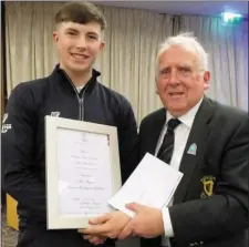  ??  ?? John Ferriter, Leinster Branch GUI chairman, presents Alex with the Leinster Order of Merit certificat­e for 2017 after a year in which he won the Leinster Boys U-17 Championsh­ip, finished second in the Under-16 Close, third in the provincial U-16 Open Championsh­ip and was part of the Laytown & Bettystown Under-18 Fred Daly squad who were winners of the Leinster Plate.