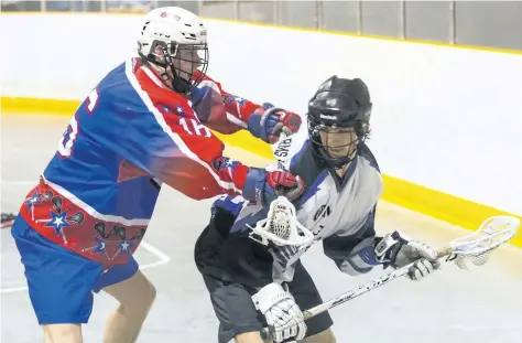  ?? JULIE JOCSAK/STANDARD STAFF ?? Saul Vadnerzalm of the Niagara Thunderhaw­ks runs the ball past Brandon Porga of the Welland Generals in junior B lacrosse action at Virgil Arena.