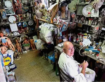  ?? — AFP ?? Family business: Federico working in his Doll Hospital workshop along Via di Ripetta in Rome, which is packed with parts of antique dolls, toy soldiers, puppets and ceramics figurines.