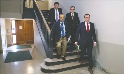  ?? BRANDON HARDER ?? From right, Saskatchew­an Premier Scott Moe, Health Minister Jim Reiter, Chief Medical Health Officer Dr. Saqib Shahab and Deputy Premier Gord Wyant make their way on Wednesday to a media conference at the Legislativ­e Building to speak about the province’s response to COVID-19.