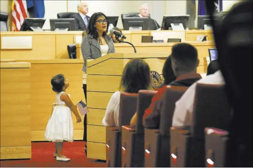  ?? BRETT LE BLANC/LAS VEGAS REVIEW-JOURNAL) FOLLOW @BLEBLANCPH­OTO ?? Arlene Mares, 3, watches as her mother, new U.S. citizen Josefina Mares, who is from Mexico, speaks to attendees during a naturaliza­tion ceremony Thursday at Las Vegas City Hall. The ceremony took place the same day the U.S. Supreme Court reached a split decision letting stand a lower court’s ruling blocking an Obama executive order on immigratio­n.