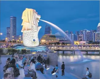  ?? Tuul & Bruno Morandi Getty Images ?? SINGAPORE, giant merlion included, is a perfect jumping-off-spot for cruises of Southeast Asia.