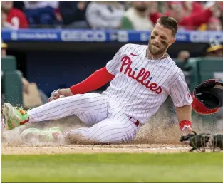  ?? LAURENCE KESTERSON — THE ASSOCIATED PRESS ?? The Phillies’ Bryce Harper scores on an RBI double by Rhys Hoskins during the third inning against the Oakland Athletics on Friday at Citizens Bank Park.