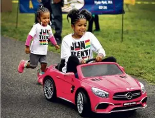  ?? ?? Riha Reis, of Dorchester, chased after her sister, Jayda, who was driving a motorized car at Franklin Park.