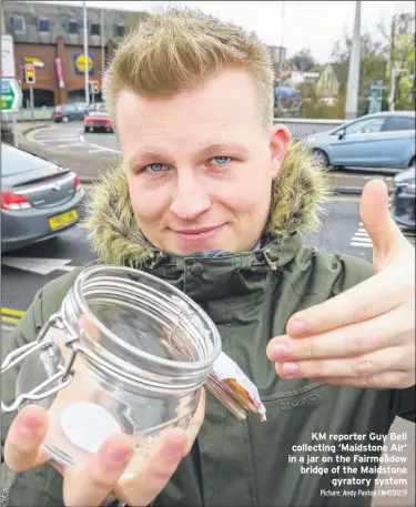  ?? Picture: Andy Payton FM4701219 ?? KM reporter Guy Bell collecting ‘Maidstone Air’ in a jar on the Fairmeadow bridge of the Maidstone gyratory system