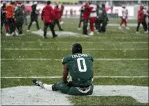  ?? CARLOS OSORIO — THE ASSOCIATED PRESS ?? Michigan State wide receiver Keon Coleman sits in the end zone as Indiana celebrates the win after the second overtime of Saturday’s game in East Lansing.