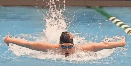  ?? MIKE CARDEW/AKRON BEACON JOURNAL ?? Marlington’s Leah Guess swims in the final heat of the girls 100 butterfly in the Division II district meet on Friday at Cleveland State.