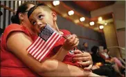  ?? MARIO TAMA / GETTY IMAGES ?? Young U.S. citizen Sergio Montana, originally from Mexico, holds an American flag during a citizenshi­p celebratio­n for young people on Monday in Los Angeles.