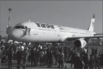  ?? The Associated Press ?? AIRBUS: In this Jan. 12, 2017, file photo, the pilot of Iran Air’s new Airbus plane waves a national flag after landing at Mehrabad Internatio­nal Airport in Tehran, Iran. From brand-new airplanes to oilfields, billions of dollars of deals stand on the...