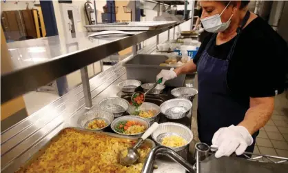  ?? ?? A cafeteria worker prepares lunch for students at Freedom preparator­y academy in Provo, Utah. Photograph: George Frey/AFP/Getty Images