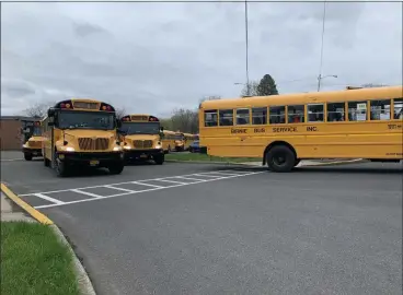  ?? TANIA BARRICKLO — DAILY FREEMAN ?? Buses are shown outside J. Watson Bailey Middle School in Kingston, N.Y., at the end of the day on Monday, April 12.