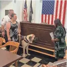  ?? STEPHEN LANDRY/THE GARDNER NEWS ?? Gardner City Clerk Titi Siriphan swears in Sully, the Gardner Fire Department's first therapy dog, as owners Lt. Eric Hulette and Denise Hulette look on.