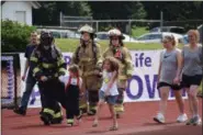  ?? MARIAN DENNIS — MEDIANEWS GROUP ?? Area firefighte­rs take a lap around the track during the Relay for Life Pottstown Saturday.