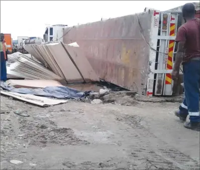  ??  ?? A Mutare-bound cross-border haulage truck carrying industrial timber boards fell on its side after its driver failed to negotiate an uneven terrain in the Beitbridge Border Post, which is under rehabilita­tion. This is the third truck to land on its side at that section of the border post.