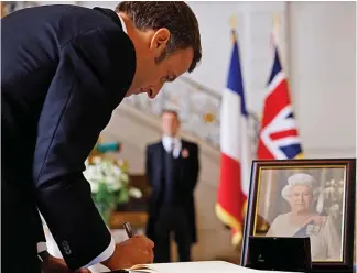  ?? ?? Grief: Mr Macron signs a condolence book at the British embassy in Paris