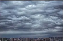  ??  ?? Asperitas clouds may look menacing but rarely result in a storm. These clouds were forming over Beijing.