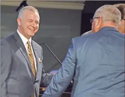  ?? Henry Durand, Christian Index ?? Newly elected president Josh Saefkow walks off the stage after his election as president was announced by outgoing president Kevin Williams, right, at the 200th annual meeting of the Georgia Baptist Convention in Augusta on Nov. 15.