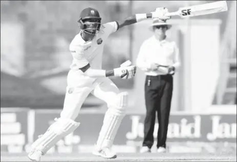  ??  ?? STANDING TALL: Roston Chase celebrates another landmark during his superb unbeaten 101 on the final day of the third Test against Pakistan yesterday. (Photo courtesy WICB Media)