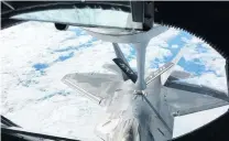  ?? PHOTO: REUTERS ?? Topup . . . One of two United States Air Force F22 stealth fighter jets receives fuel midair from a KC135 refuelling plane over Norway on the way to a joint training exercise yesterday.