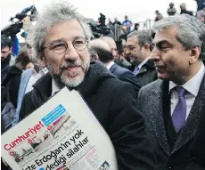  ?? BULENT KILIC/AFP/GETTY IMAGES ?? Turkish daily Cumhuriyet’s editor-in-chief Can Dundar and Ankara editor Erdem Gul, right, are on trial for publishing images of local officials searching Syria-bound trucks from 2014 they say prove Turkey was smuggling arms to Islamist rebels....
