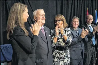  ?? MARK GOUDGE/SALTWIRE NETWORK ?? Brian Mulroney is applauded by his daughter Caroline and wife Dr. Mila Mulroney after his speech during sod turning for the Brian Mulroney Institute of Government and Mulroney Hall building at StFX Wednesday.