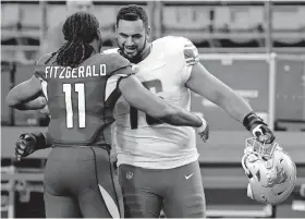  ??  ?? Arizona Cardinals wide receiver Larry Fitzgerald greets Detroit Lions offensive guard Oday Aboushi in September after an NFL football game in Glendale, Ariz. [AP FILE]