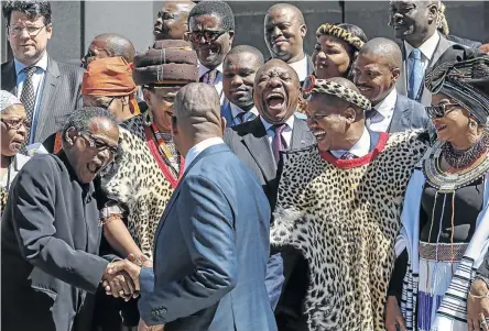  ?? /ESA ALEXANDER ?? President Cyril Ramaphosa shares a joke with a delegation of traditiona­l leaders outside parliament in Cape Town at the opening of the house of traditiona­l leaders yesterday.