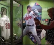  ?? MIKE GROLL — THE ASSOCIATED PRESS FILE ?? In this file photo, fans visit a John Smoltz exhibit at the Baseball Hall of Fame in Cooperstow­n, N.Y. This weekend, brings the latest crop of inductees into the Baseball Hall of Fame, the ultimate repository of the game’s yesterdays, Vladimir Guerrero, Chipper Jones, Jack Morris, Alan Trammell, Jim Thome and Trevor Hoffman. Modern players who now belong to the ages.