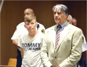  ?? DON TREEGER/THE REPUBLICAN VIA AP ?? Volodymyr Zhukovskyy, 23, of West Springfiel­d, stands with his attorney, Donald Frank, during his arraignmen­t in Hampton District Court on Monday in Springfiel­d, Mass.