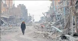  ?? AFP FILE ?? ■ A civilian returns to the war-torn city of Hajin in Syria's Deir Ezzor province.