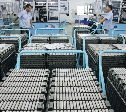  ?? CHINATOPIX VIA AP ?? Workers transfer lithium-ion batteries in a factory in Taizhou in east China’s Jiangsu province last month. China’s shipments to the U.S. rose 13 per cent in July from a year earlier, to US$41.5 billion, as the U.S.’s extra 25-per-cent tariffs on...