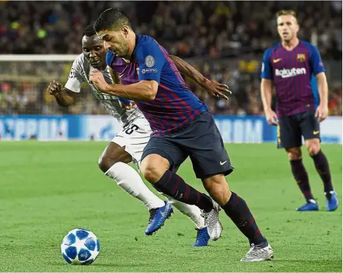  ??  ?? That’s mine: Inter Milan defender Kwadwo Asamoah (left) vying for the ball with Barcelona forward Luis Suarez (centre) during the Champions League Group B match at Nou Camp on Wednesday. — AFP