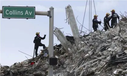  ??  ?? Rescuers search for victims in Surfside, Florida, on Monday. Photograph: Carl Juste/AP