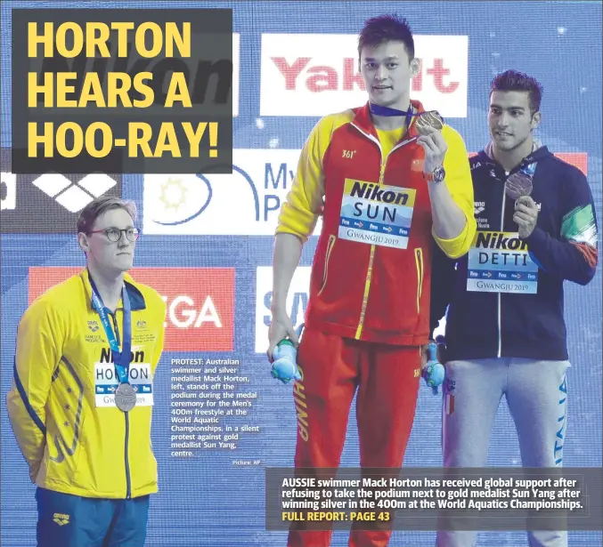  ?? Picture: AP ?? PROTEST: Australian swimmer and silver medallist Mack Horton, left, stands off the podium during the medal ceremony for the Men’s 400m freestyle at the World Aquatic Championsh­ips, in a silent protest against gold medallist Sun Yang, centre.