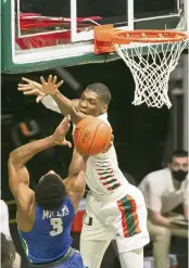  ?? MATIAS J. OCNER mocner@miamiheral­d.com ?? Hurricanes forward Anthony Walker fouls Florida Gulf Coast Eagles guard Franco Miller Jr. in the first half.