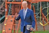  ?? AP PHOTO/ANDREW HARNIK ?? President Joe Biden waves to members of the media Friday as he walks toward Marine One on the South Lawn of the White House in Washington.