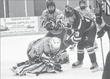  ?? TINA COMEAU ?? Vikings player Jaden Watkins looks to hold back Avon View player Hayden Burgess as Vikings goalie Tyson Peters makes a save during a Nov. 2 high school hockey game.