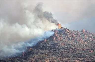  ?? MICHAEL CHOW/THE REPUBLIC FILE ?? The Telegraph Fire burns in the Tonto National Forest near Superior last month.