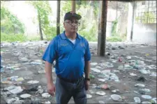  ?? JOHN BERRY — THE TRENTONIAN ?? Trenton Mayor Reed Gusciora and some of the endless trash throughout the buildings as he did a walkthroug­h of the Roebling Block II buildings Wednesday as the city prepares to clean them up to attract potential developers to the property.