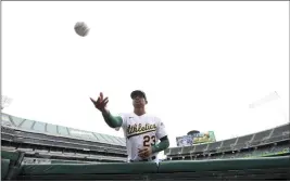  ?? JED JACOBSOHN — THE ASSOCIATED PRESS ?? Oakland Athletics' Christian Bethancour­t (23) throws a ball to a fan before a baseball game against the Baltimore Orioles in Oakland Thursday.
