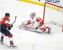  ?? WILFREDO LEE/AP ?? Florida Panthers center Aleksander Barkov scores against Detroit Red Wings goaltender Petr Mrazek during the second period on Saturday.