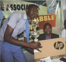  ??  ?? Dr Olabodunri­n Waheed Oki (middle) presents prizes to Albert Emmanuel of Lagos Model College, the winner of senior category of Ola-Oki Lagos Scrabble Competitio­n held in Badagry recently